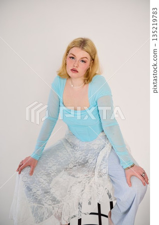 Chic woman in vibrant clothing displays assured attitude 135219783