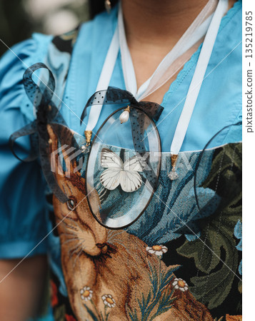 Stylish outfit featuring floral embroidery and layered textured accessories 135219785