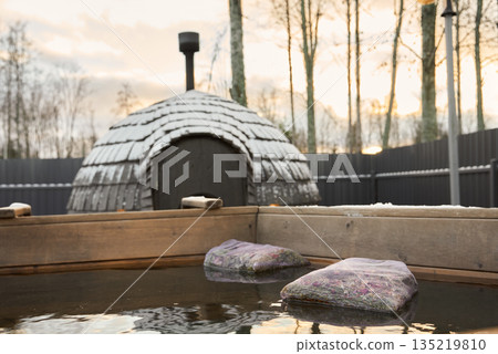Calming outdoor bathing area with natural surroundings and warm lighting Calming outdoor bathing area with natural surroundings and warm lighting 135219810