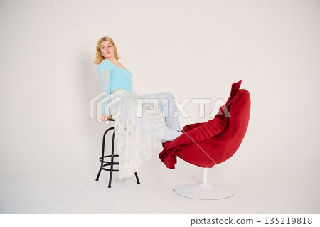 Simplistic studio portrait, Casual female model in vibrant clothing Simplistic studio portrait, Casual female model in vibrant clothing 135219818
