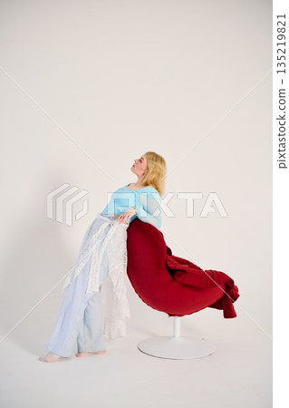 contemporary dancer balance white woman with red chair 135219821