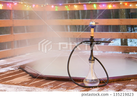 Serene snowy setting featuring lone hookah and soft illumination 135219823