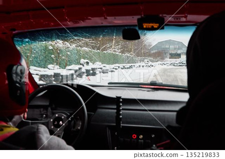 Inside rally car navigating snowcovered mountain stages with focus Inside rally car navigating snowcovered mountain stages with focus 135219833