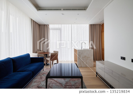 Modern interior featuring navy furniture and warm lighting ambiance 135219834