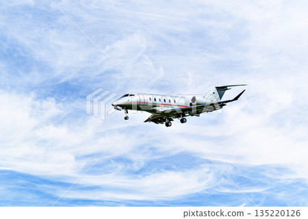 Private business plane flying under blue sky with white cloud Private business plane flying under blue sky with white cloud 135220126