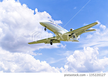 Private business plane flying under blue sky with white cloud Private business plane flying under blue sky with white cloud 135220127