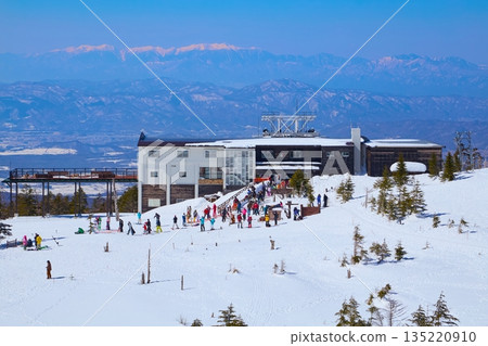 View of the Kita-Yatsugatake Ropeway summit station and the Central Alps from a small garden in Chino City, Nagano Prefecture in winter 135220910