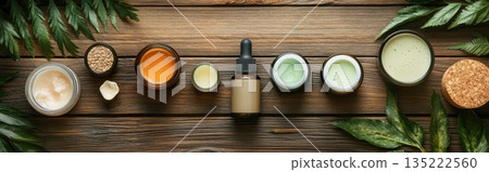 Natural skincare products arranged neatly on wooden surface with green leaves 135222560