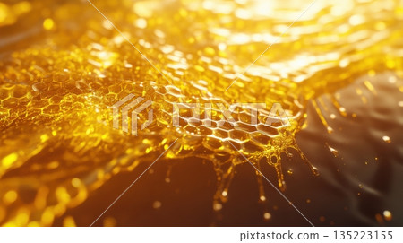 Golden honey dripping from honeycomb creates a mesmerizing natural pattern 135223155