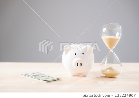Piggy bank, money, and hourglass represent saving time and financial investment, a crucial concept for future planning and smart business strategies, securing retirement wealth 135224907