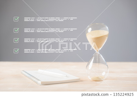 Hourglass displays passing time, management concept visualized for efficient planning, notebook and pen ready for goal setting, digital checklist shows achieved business tasks and project progress Hourglass displays passing time, management concept visualized for efficient planning, notebook and pen ready for goal setting, digital checklist shows achieved business tasks and project progress 135224925