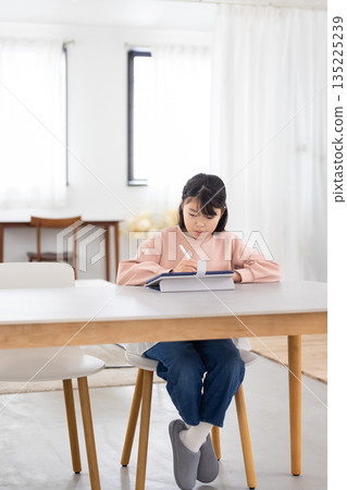 Elementary school girl learning on a tablet 135225239