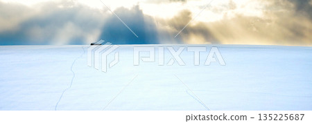 The sun setting over the snowy fields of Biei, Hokkaido in winter, and rays of light from the clouds The sun setting over the snowy fields of Biei, Hokkaido in winter, and rays of light from the clouds 135225687