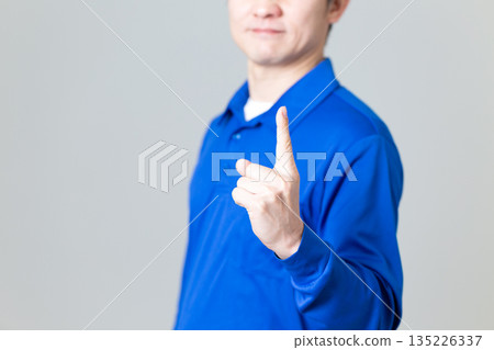 A middle-aged man wearing blue work clothes in the logistics and transportation industry A middle-aged man wearing blue work clothes in the logistics and transportation industry 135226337