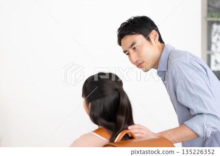 A father talking seriously to his elementary school daughter carrying a school bag A father talking seriously to his elementary school daughter carrying a school bag 135226352
