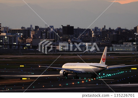 Passenger plane heading for a night flight Passenger plane and guide lights Passenger plane heading for a night flight Passenger plane and guide lights 135226701