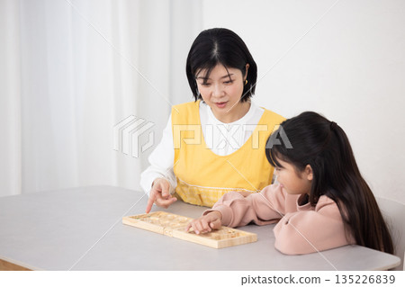 A female after-school teacher teaching female students 135226839