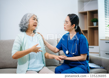 Asian nurse providing home healthcare to elderly woman. Professional caregiver offering senior care, medical consultation, compassion Asian nurse providing home healthcare to elderly woman. Professional caregiver offering senior care, medical consultation, compassion 135226895