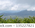 A view of the cityscape and mountains in a basin beneath a sea of clouds 135227821