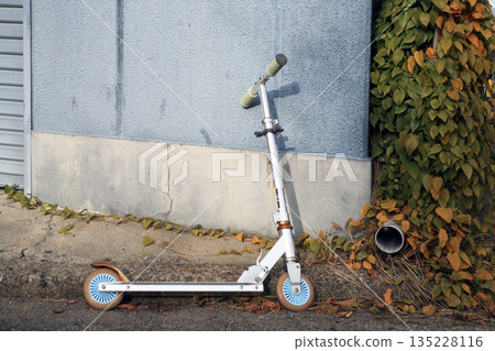 A kick scooter parked at a private home A kick scooter parked at a private home 135228116