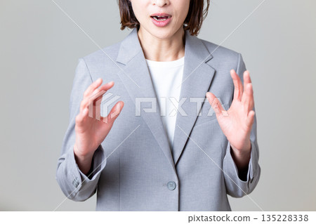 Surprised middle-aged female business woman 135228338