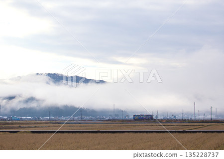 A decorated train running through the morning mist 135228737