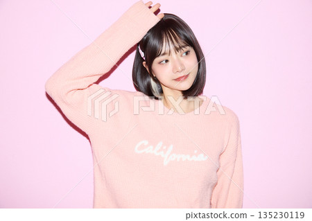Portrait of a young Asian woman posing cutely against a pink background 135230119