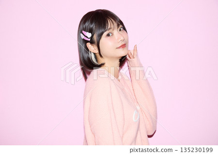 Portrait of a young Asian woman posing cutely against a pink background 135230199