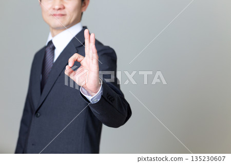 A middle-aged male businessman in a suit making a circle sign A middle-aged male businessman in a suit making a circle sign 135230607