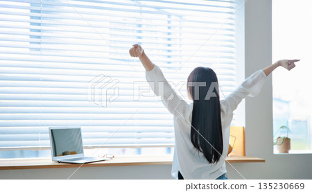 A woman in her twenties operating a laptop A woman in her twenties operating a laptop 135230669