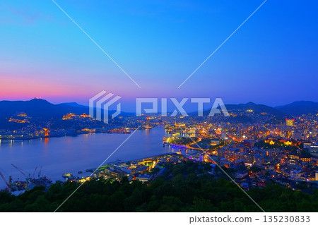 Night view of Nagasaki Port and Nagasaki city with the magic hour sky as a backdrop as seen from Nabekanmuriyama Observatory Ver.1 135230833