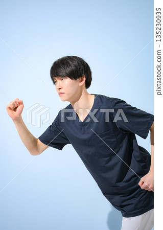 A young male nurse or doctor wearing a scrub on a light blue background, smiling in a running pose at the start, looking for a job or changing jobs, full body A young male nurse or doctor wearing a scrub on a light blue background, smiling in a running pose at the start, looking for a job or changing jobs, full body 135230935