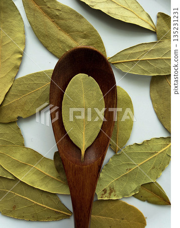 Bay Leaves in Wooden Spoon Flat Lay on White Background 135231231