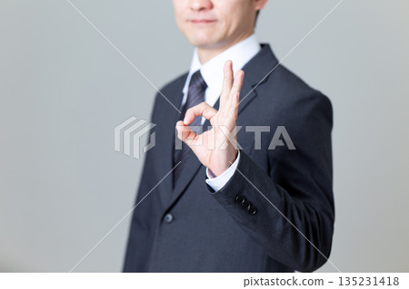 A middle-aged male businessman in a suit making a circle sign A middle-aged male businessman in a suit making a circle sign 135231418