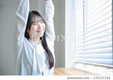 Beauty portrait of a woman in her twenties stretching 135231728