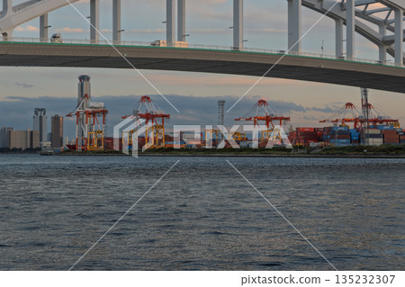 Osaka Port, Yumeshima Container Terminal at dusk with illuminated gantry cranes (logistics, 24-hour operation, evening view) Osaka Port, Yumeshima Container Terminal at dusk with illuminated gantry cranes (logistics, 24-hour operation, evening view) 135232307