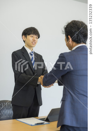 Businessman listening to a smile and talking 135232339