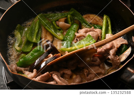Stir-fried eggplant, green pepper, and pork with miso while cooking Stir-fried eggplant, green pepper, and pork with miso while cooking 135232588