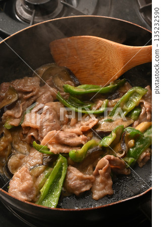 Stir-fried eggplant, green pepper, and pork with miso while cooking Stir-fried eggplant, green pepper, and pork with miso while cooking 135232590