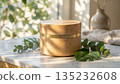 Wooden cosmetic jar mockup on marble table with green leaves. 135232608