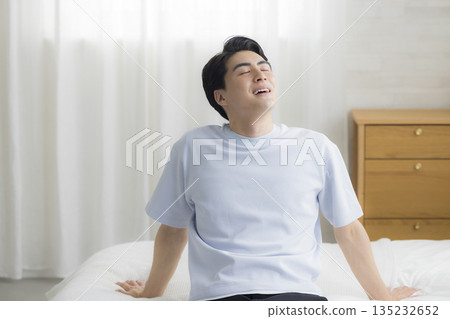 Young man in bedroom Young man in bedroom 135232652
