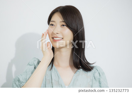 A young woman wearing a light blue dress A young woman wearing a light blue dress 135232773