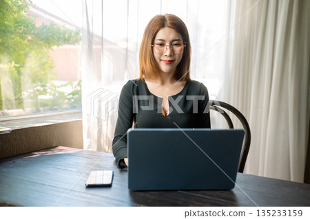 Happy woman working online from home, lifestyle and small business. Happy woman working online from home, lifestyle and small business. 135233159