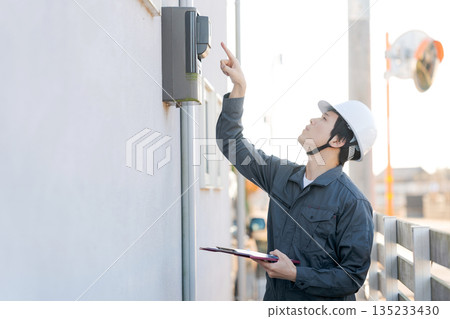 A person inspecting a water heater 135233430