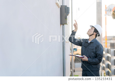 A person inspecting a water heater 135233431