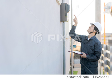 A person inspecting a water heater 135233432