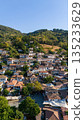 Aerial view of Sirince village with traditional houses and tiled roofs on a green hillside. Historic rural settlement and popular travel destination in Turkey. 135233629