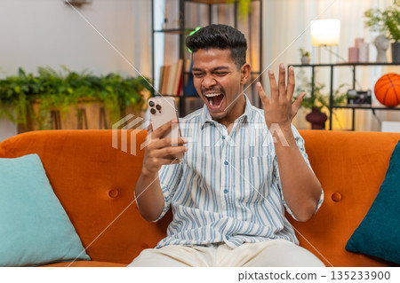 Indian man scrolls smartphone feed sees big discounts says wow smiles at online shop offers news hot Indian man scrolls smartphone feed sees big discounts says wow smiles at online shop offers news hot 135233900