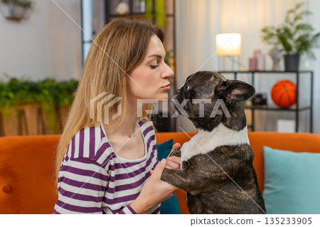 Middle-aged woman with dog face closeup portrait gentle smile sweet bond warm heart happy mood shot Middle-aged woman with dog face closeup portrait gentle smile sweet bond warm heart happy mood shot 135233905