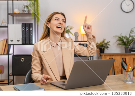 Businesswoman finds idea for presentation eureka moment smiles and working on deck slides quick plan Businesswoman finds idea for presentation eureka moment smiles and working on deck slides quick plan 135233913